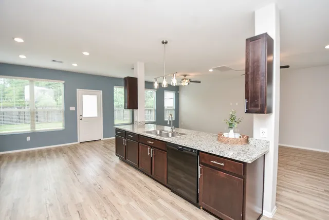a bathroom with a granite countertop sink toilet a mirror and a shower