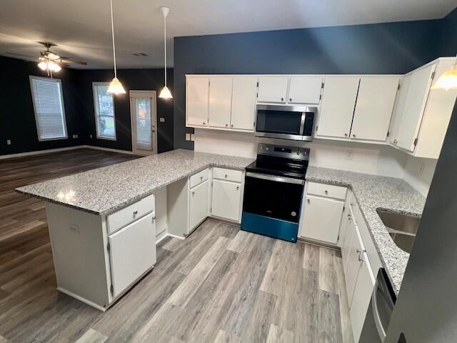 161 Walnut Street Santa Rosa Beach, FL 32459 - Photo 11 of 19 a kitchen with stainless steel appliances granite countertop a stove a sink and a microwave