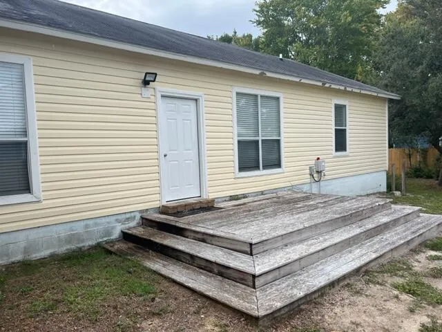 a view of a house with a yard and wooden roof