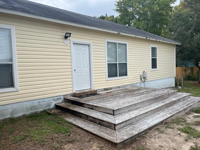 161 Walnut Street Santa Rosa Beach, FL 32459 - Photo 12 of 19 a view of a house with a yard and wooden roof