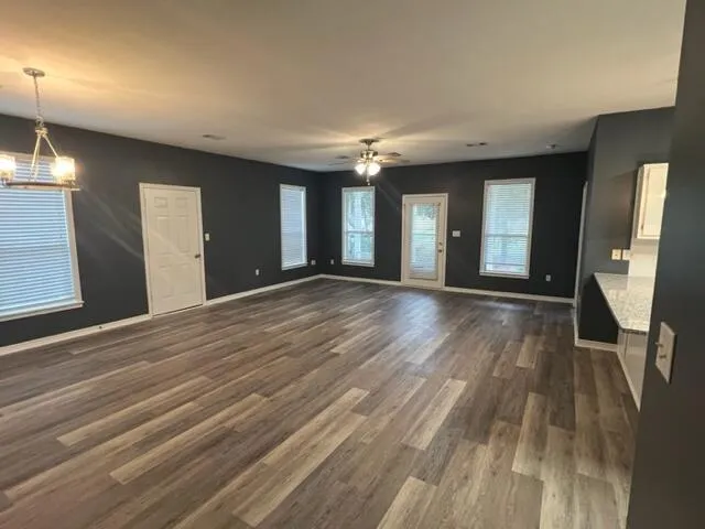 a view of a room with wooden floor