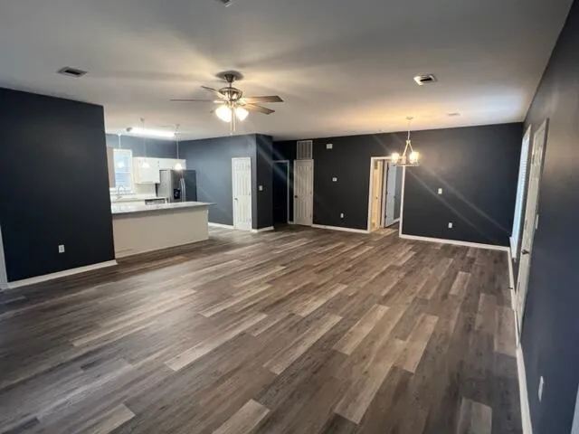 a view of a kitchen with a sink and a large window