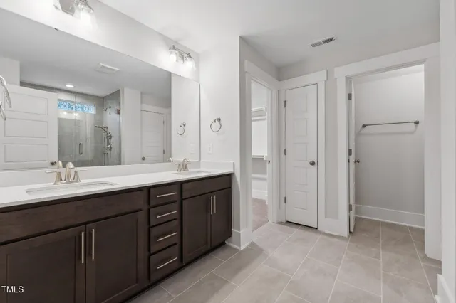 a spacious bathroom with a double vanity sink mirror and double
