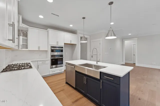 a kitchen with a sink a stove a refrigerator and cabinets