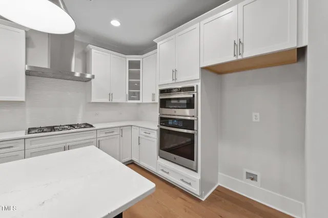 a kitchen with cabinets and stainless steel appliances