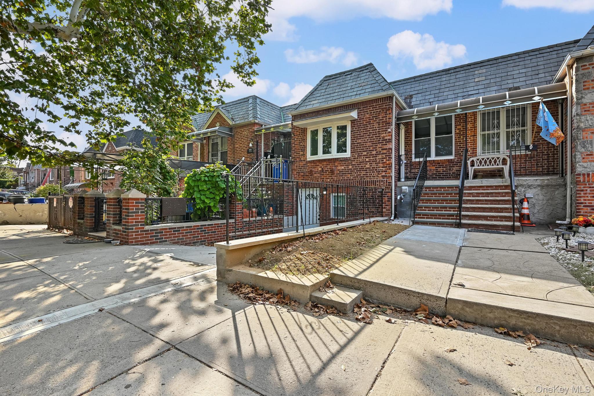 90-04 24th Road Queens, NY 11369 - Photo 3 of 20 View of front facade with a high end roof, brick siding, and mansard roof