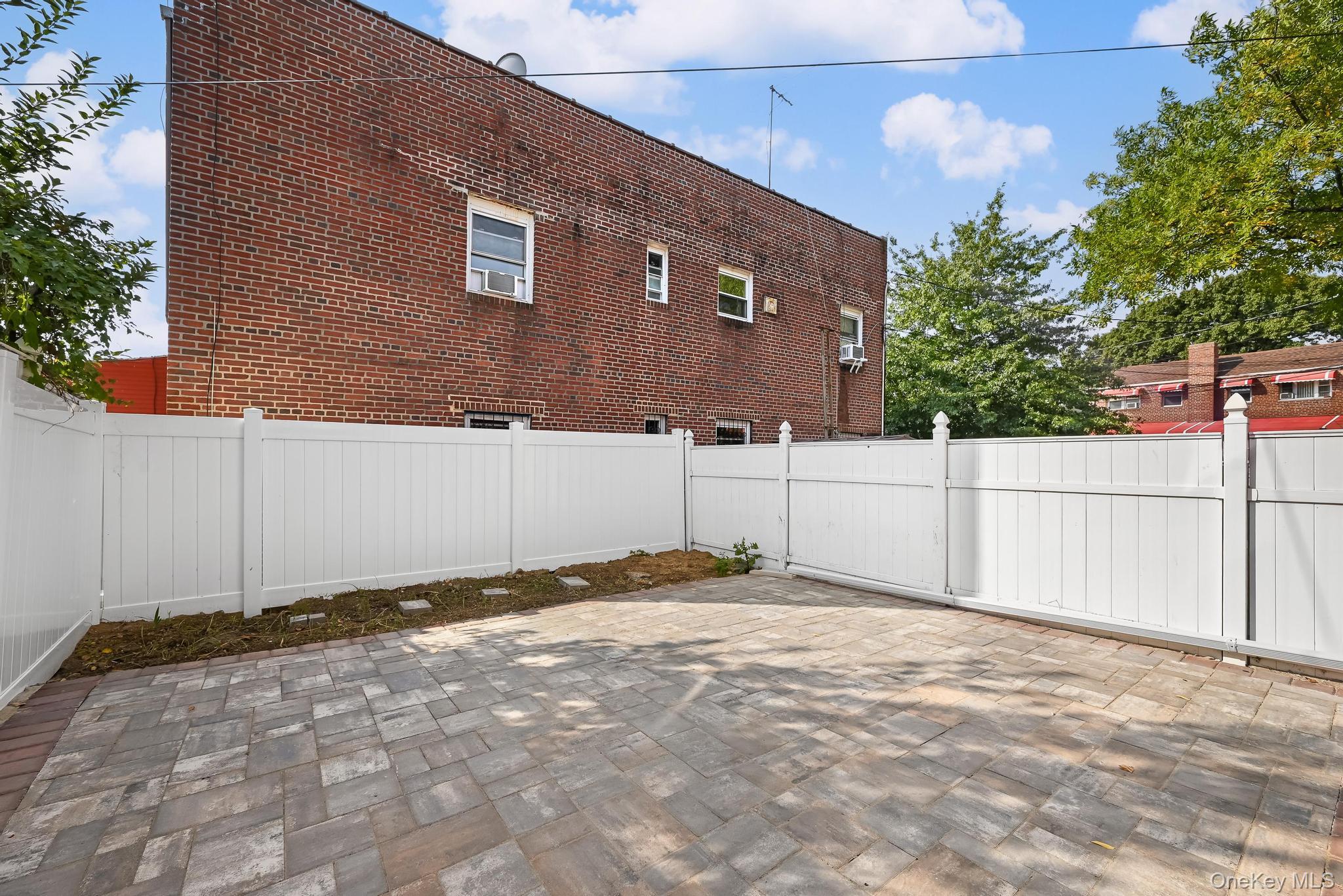 90-04 24th Road Queens, NY 11369 - Photo 5 of 20 Fenced backyard with a patio