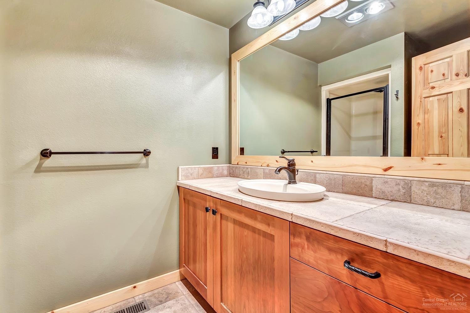 15676 Trapper Point Road Sisters, OR 97759 - Photo 18 of 25 Guest Bathroom with tile floors and coun