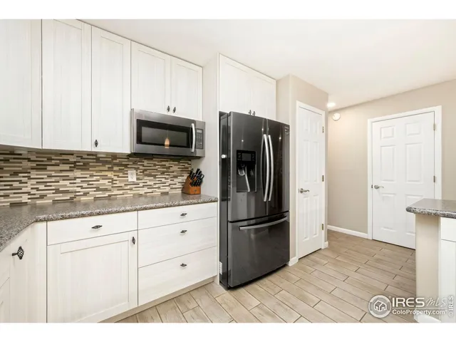 a kitchen with stainless steel appliances granite countertop a stove sink and cabinets