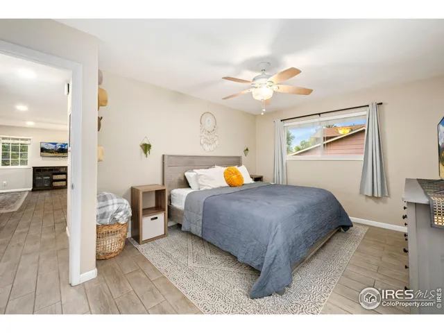 a bedroom with a bed and a flat tv screen on dresser