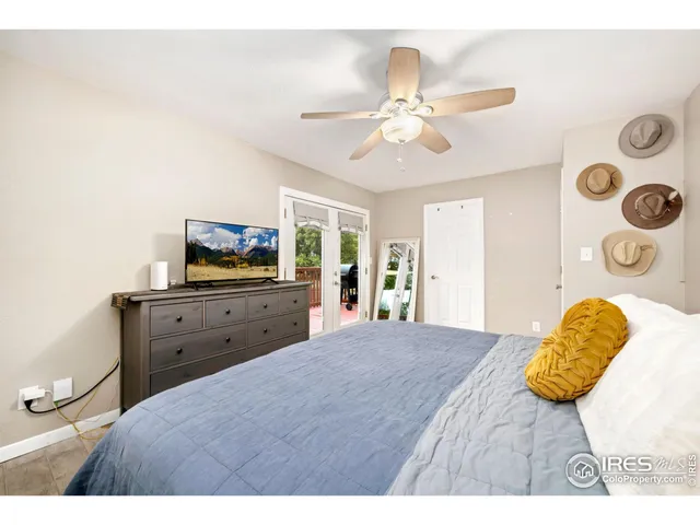 a bedroom with a bed a chandelier and a window