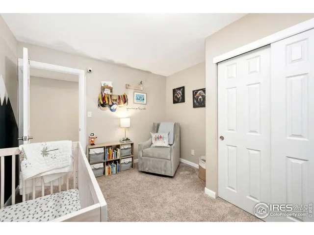 a living room with furniture and baby crib