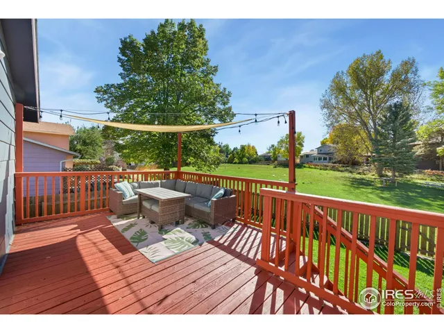 a view of a house with backyard sitting area and garden