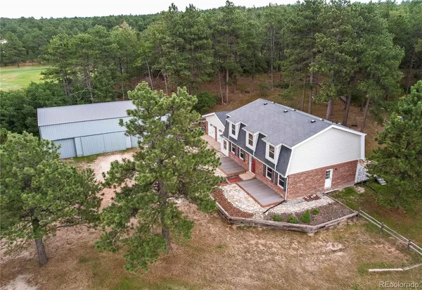 a aerial view of a house with a yard