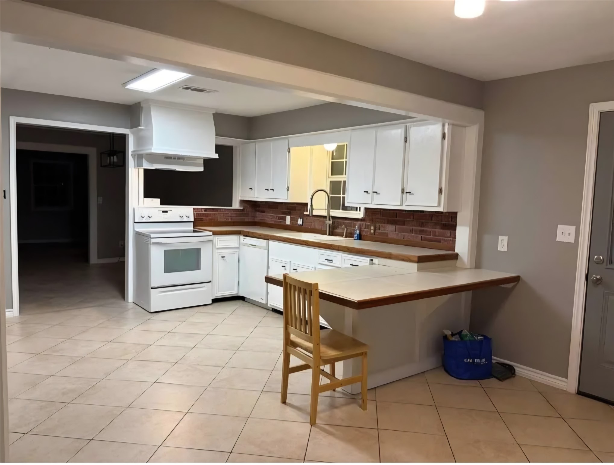 14529 Chapperal Pipeline Road, Unit A Conroe, TX 77302 - Photo 7 of 25 a kitchen with a sink cabinets and window