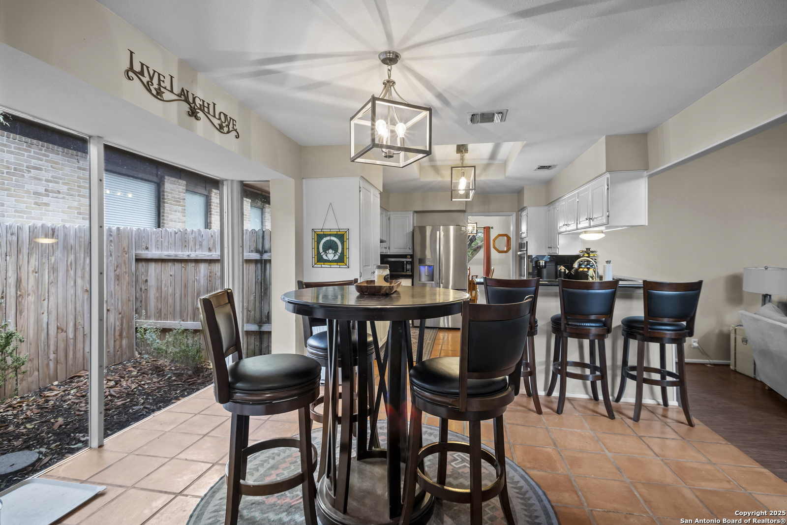 12907 Kings Forest Street San Antonio, TX 78230 - Photo 12 of 44 a view of a dining room with furniture and a chandelier