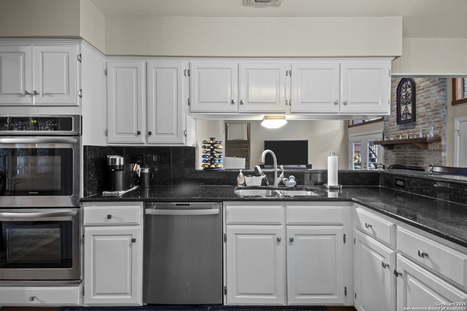 12907 Kings Forest Street San Antonio, TX 78230 - Photo 15 of 44 a kitchen with white cabinets and appliances