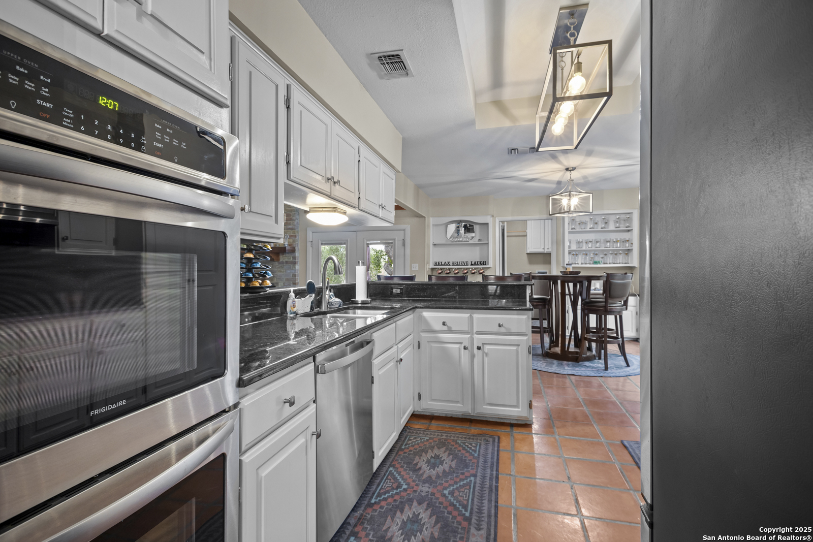 12907 Kings Forest Street San Antonio, TX 78230 - Photo 16 of 44 a kitchen with cabinets and window