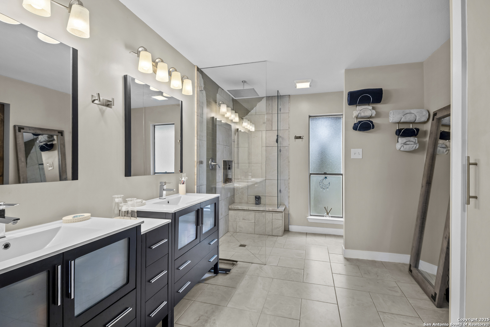12907 Kings Forest Street San Antonio, TX 78230 - Photo 25 of 44 a bathroom with a double vanity sink a toilet a mirror and shower