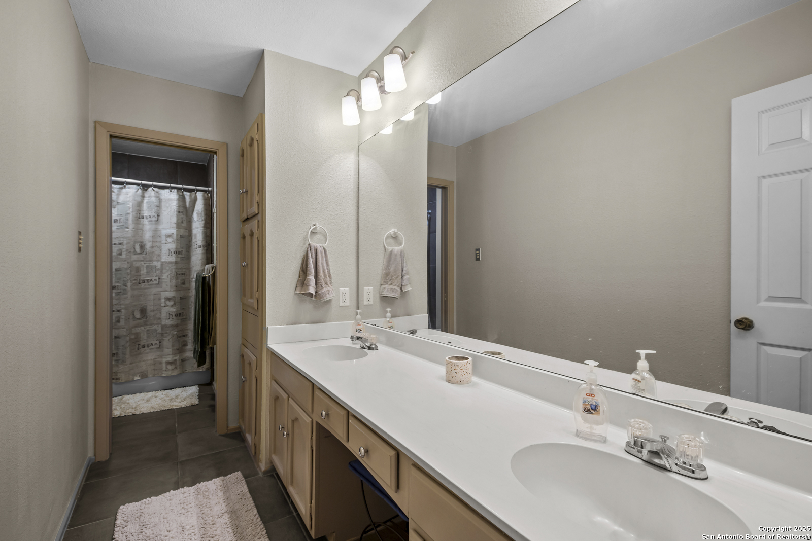 12907 Kings Forest Street San Antonio, TX 78230 - Photo 30 of 44 a bathroom with a sink double vanity and a mirror