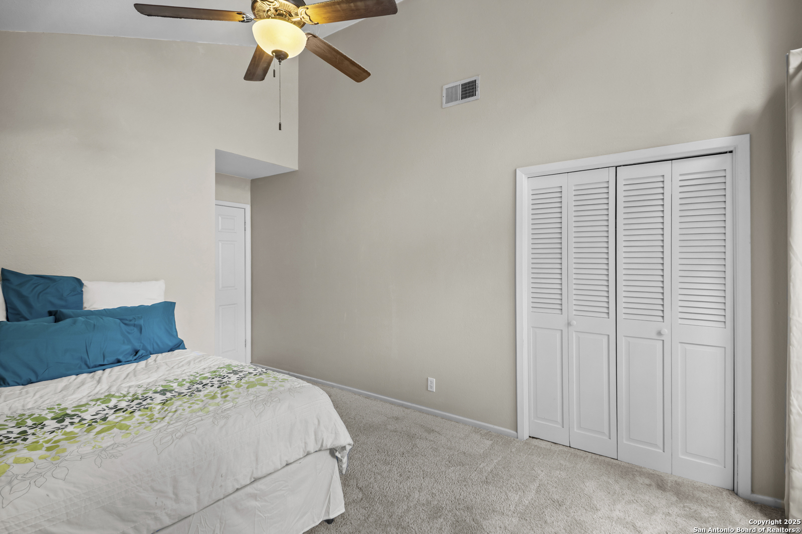 12907 Kings Forest Street San Antonio, TX 78230 - Photo 32 of 44 a bedroom with a bed and a chandelier