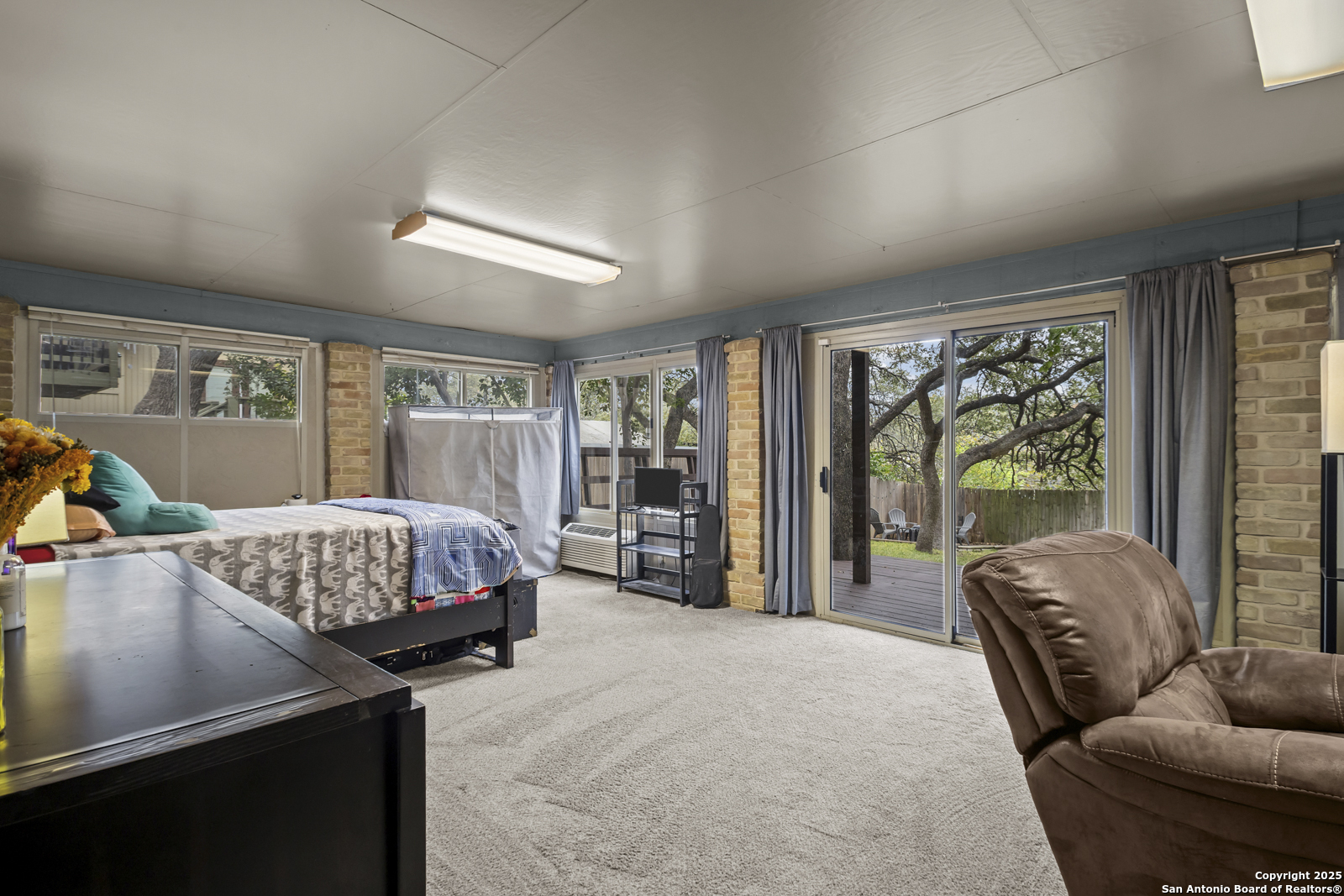 12907 Kings Forest Street San Antonio, TX 78230 - Photo 33 of 44 a living room with a bed furniture and a large window
