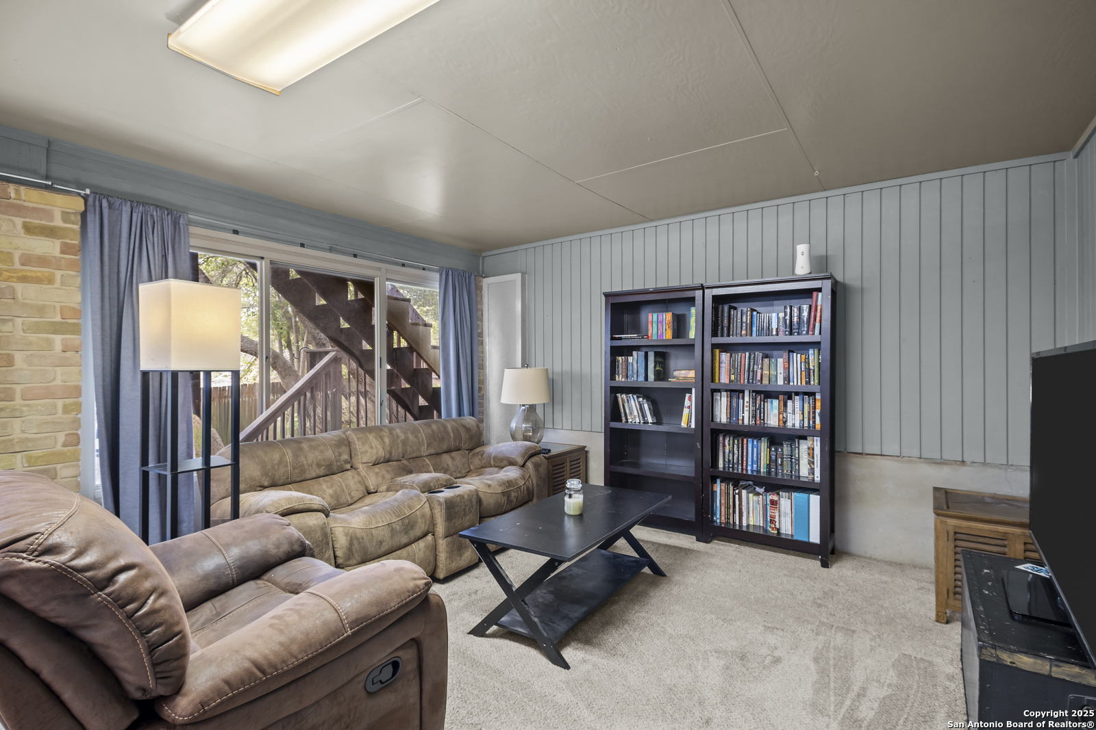 12907 Kings Forest Street San Antonio, TX 78230 - Photo 36 of 44 a living room with furniture and a flat screen tv