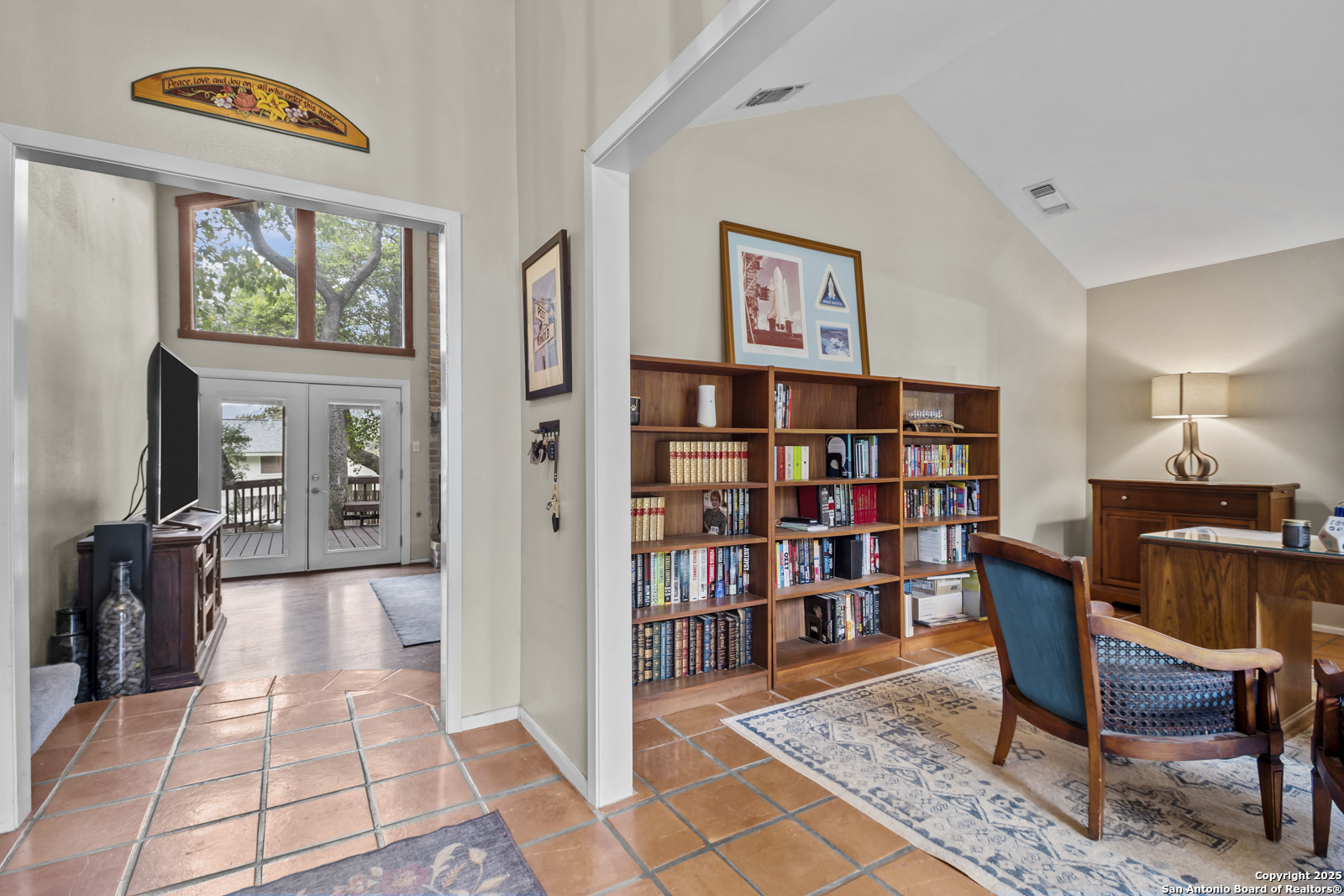 12907 Kings Forest Street San Antonio, TX 78230 - Photo 5 of 44 a view of a workspace with furniture and a bookshelf