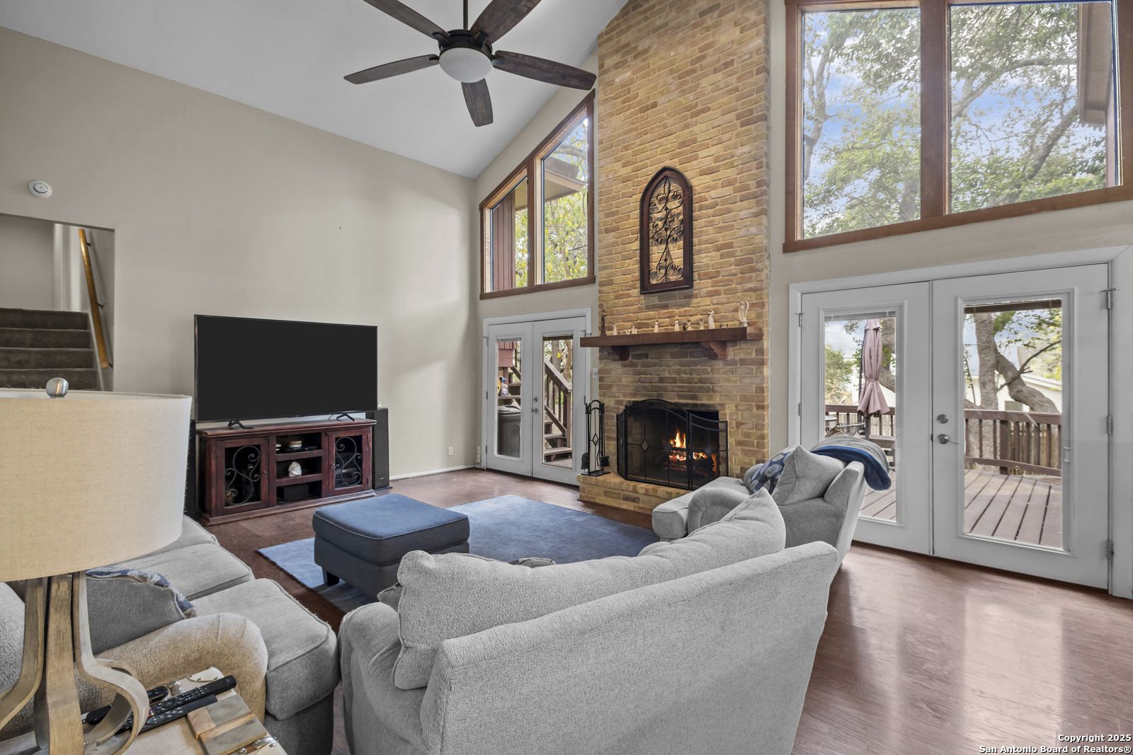 12907 Kings Forest Street San Antonio, TX 78230 - Photo 9 of 44 a living room with furniture a flat screen tv and a fireplace