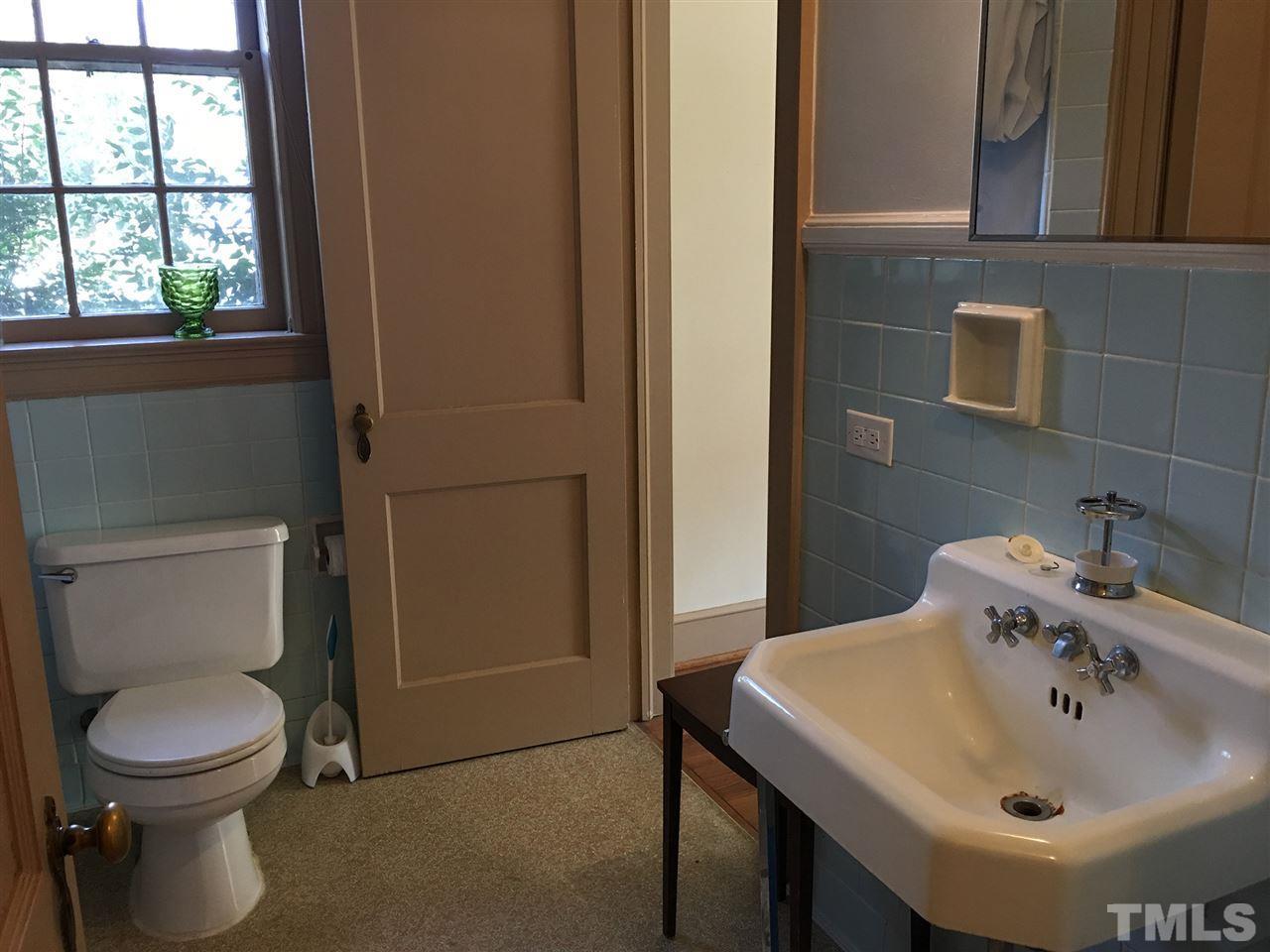 7 Sylvan Road Durham, NC 27701 - Photo 11 of 25 a bathroom with a sink a toilet and a mirror