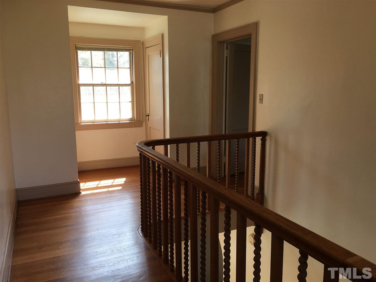 7 Sylvan Road Durham, NC 27701 - Photo 13 of 25 a view of a hallway with wooden floor and staircase