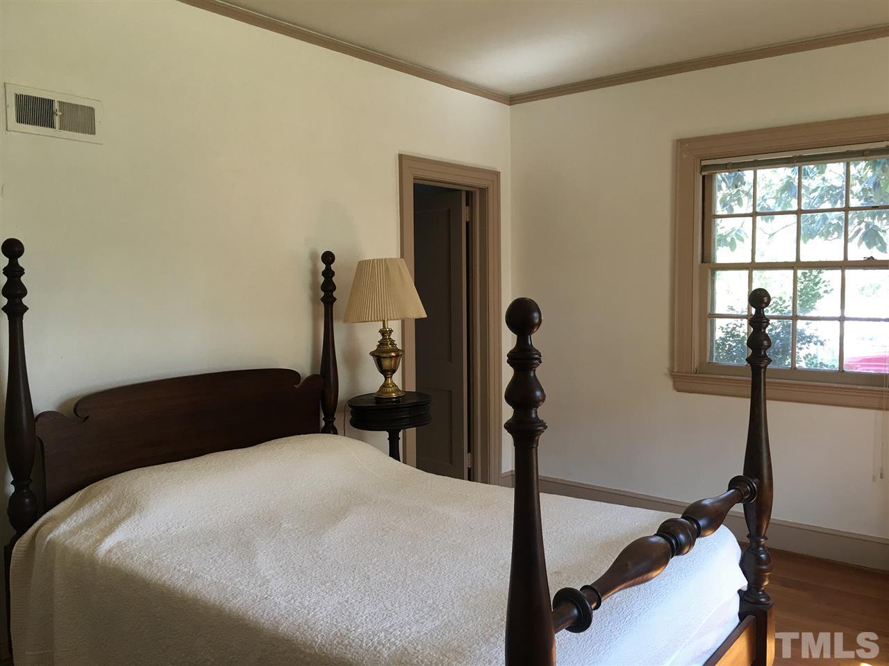 7 Sylvan Road Durham, NC 27701 - Photo 14 of 25 a bedroom with a bed and a window