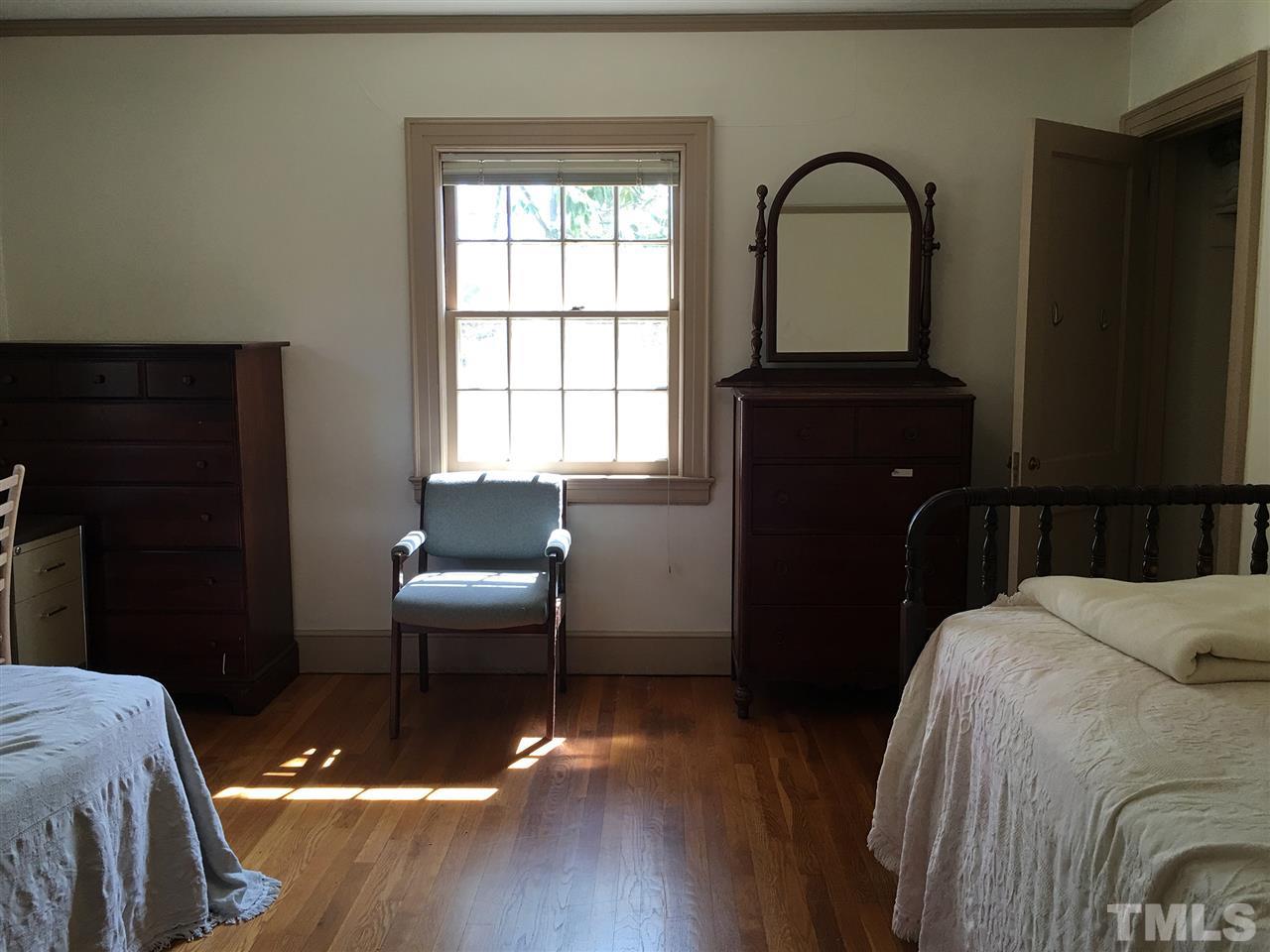 7 Sylvan Road Durham, NC 27701 - Photo 18 of 25 a bedroom with a bed and a window