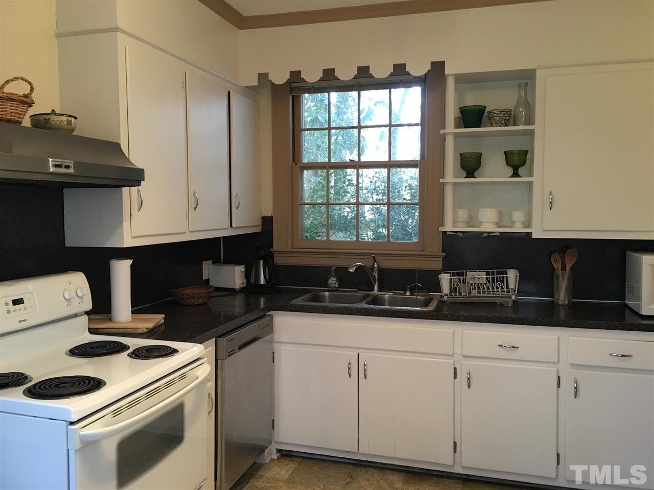 7 Sylvan Road Durham, NC 27701 - Photo 9 of 25 a kitchen with granite countertop a sink a stove and cabinets