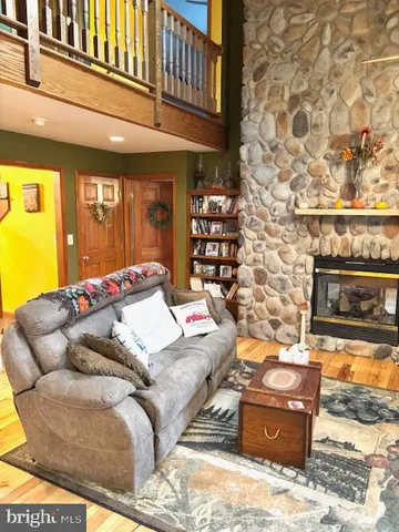 a side of a door with a fireplace and wooden floor