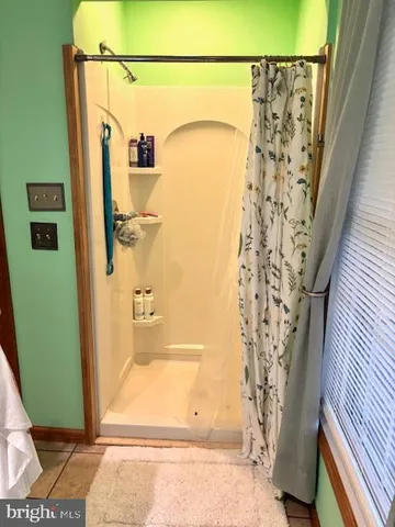 a bathroom with a tub sink and a mirror