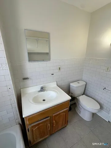 a bathroom with a sink toilet and mirror