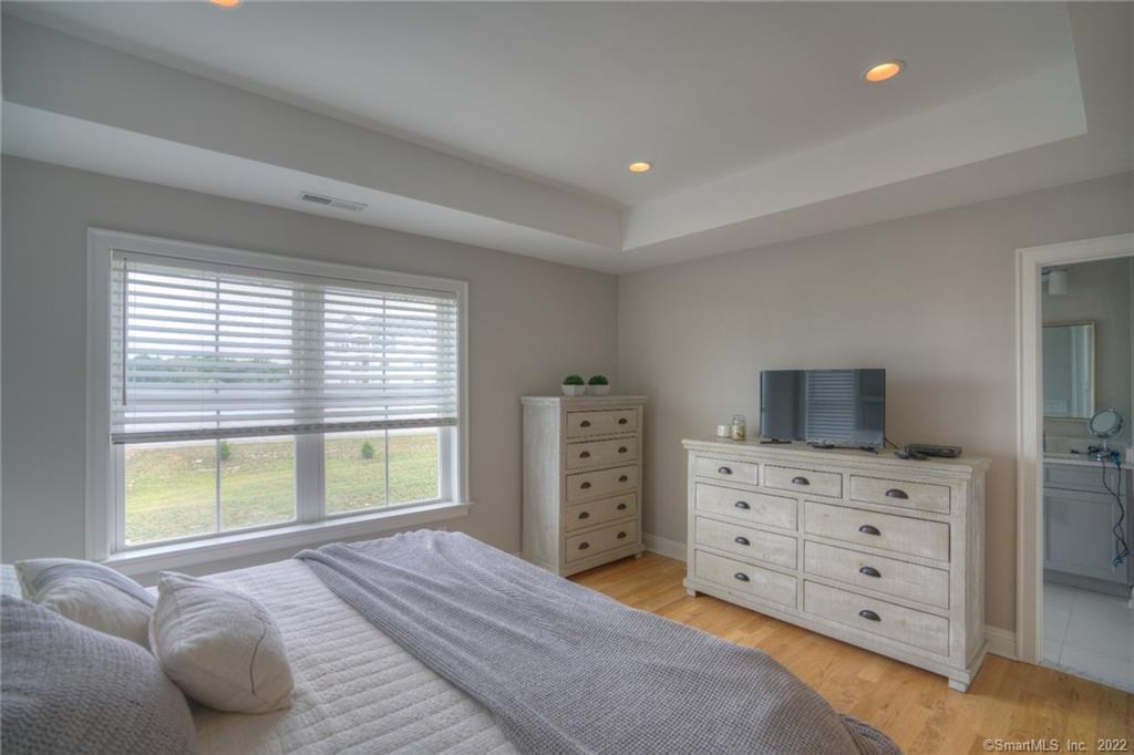 46 Park Avenue, Unit 46 Mystic, CT 06355 - Photo 16 of 28 a bedroom with a bed and furniture