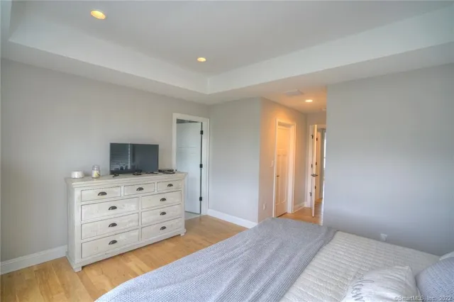 a view of bedroom with furniture and flat screen tv