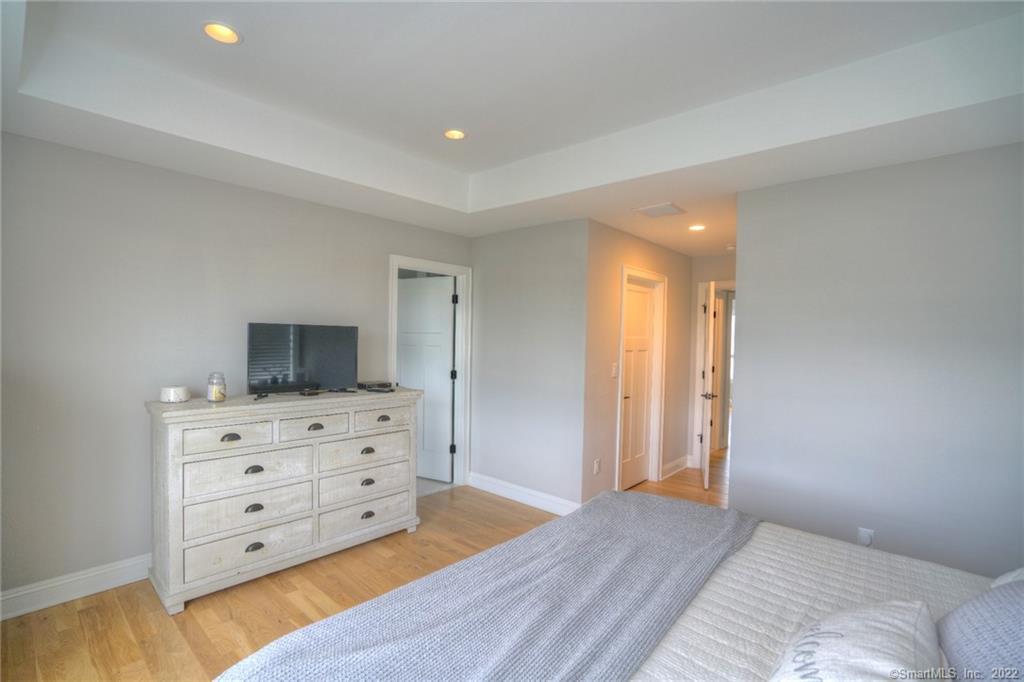46 Park Avenue, Unit 46 Mystic, CT 06355 - Photo 17 of 28 a view of bedroom with furniture and flat screen tv