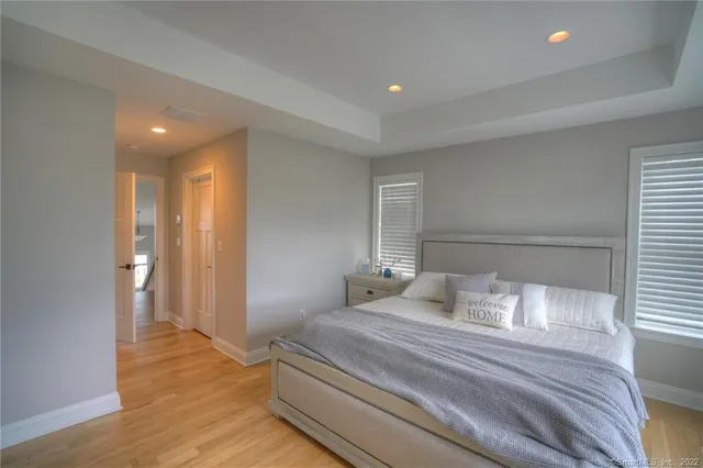 a bedroom with a bed and wooden floor