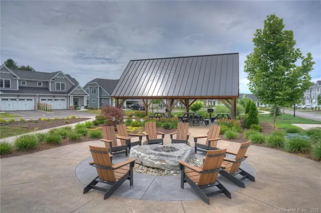 a view of a patio with table and chairs under an umbrella