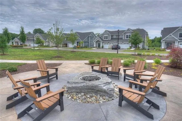 a view of a swimming pool with lounge chairs in back yard of the house