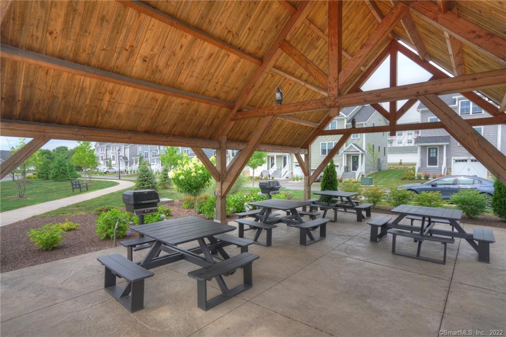 46 Park Avenue, Unit 46 Mystic, CT 06355 - Photo 28 of 28 a view of a patio with table and chairs under an umbrella