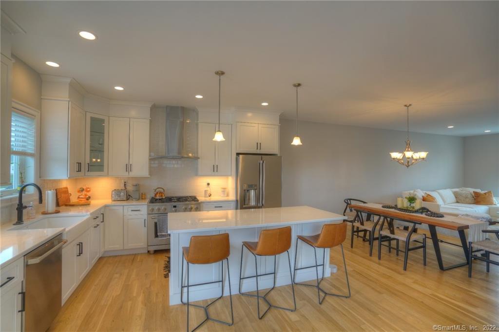 46 Park Avenue, Unit 46 Mystic, CT 06355 - Photo 3 of 28 a large kitchen with a table and chairs