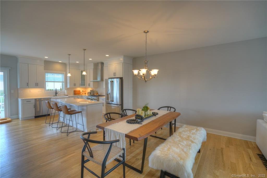 46 Park Avenue, Unit 46 Mystic, CT 06355 - Photo 6 of 28 a view of a dining room with furniture and wooden floor