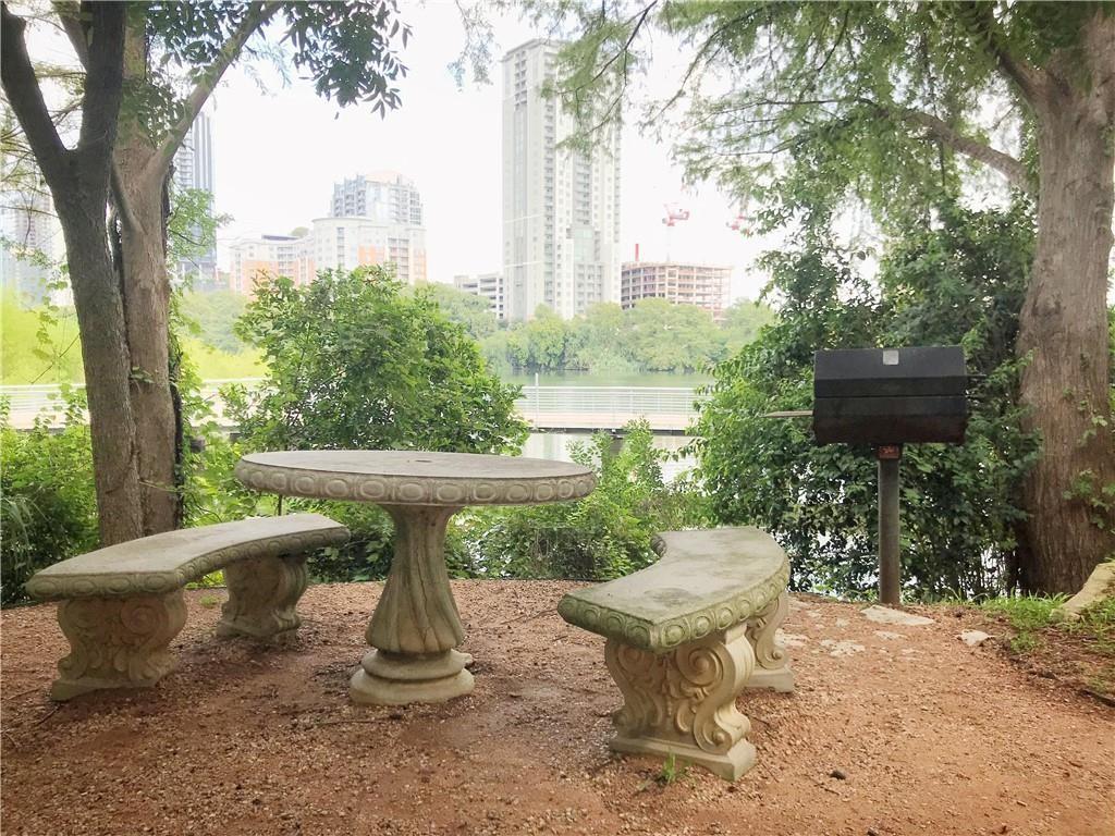 500 East Riverside Drive, Unit 154 Austin, TX 78704 - Photo 12 of 14 Outdoor amenity area featuring a stone table and benches