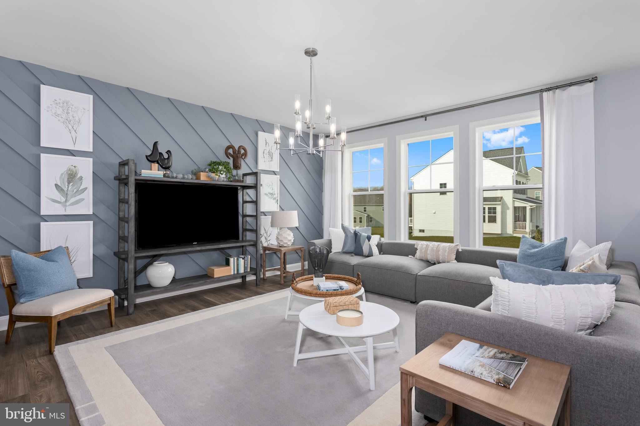 665 Stuart Street Charles Town, WV 25414 - Photo 2 of 27 a living room with furniture a flat screen tv and a large window