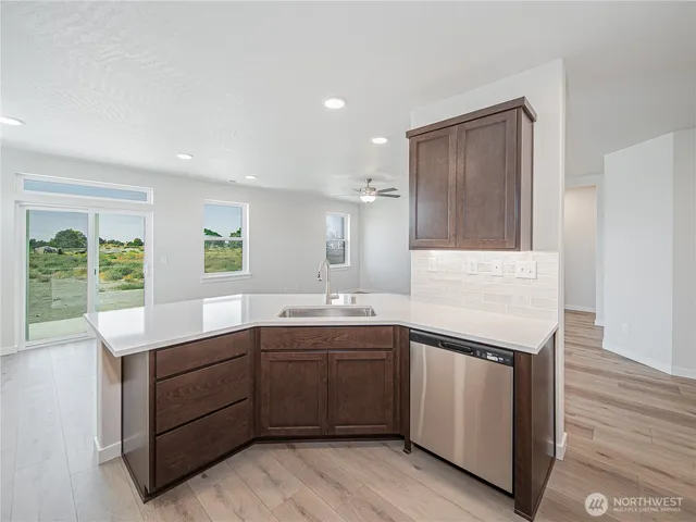 a kitchen with a sink stove and cabinets