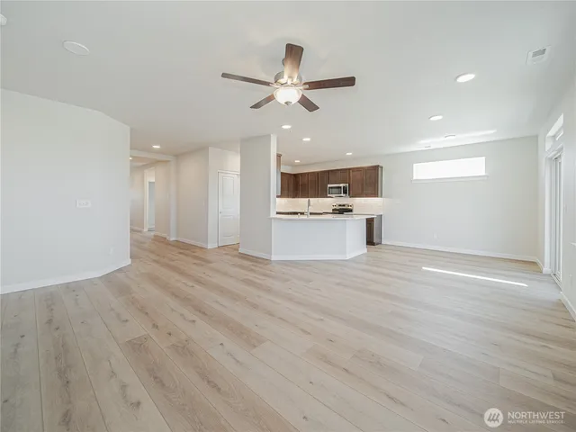 a view of a kitchen with a sink and a refrigerator